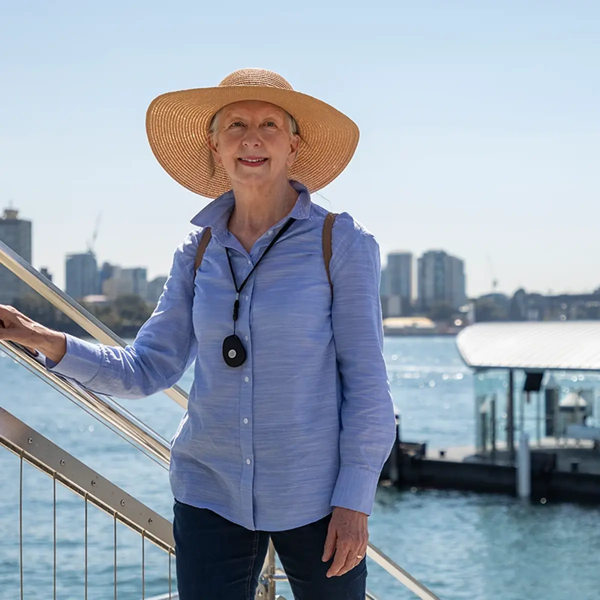 Woman wearing a LiveLife personal emergency pendant alarm outdoors