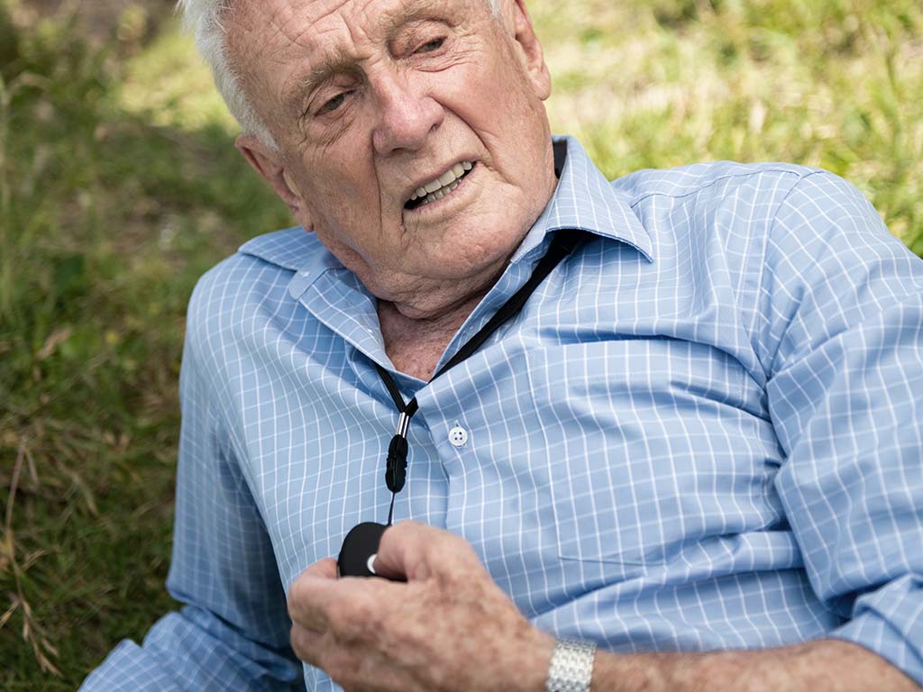 Elderly-Australian-talking-with-his-family-using-Livelife-alarm-device